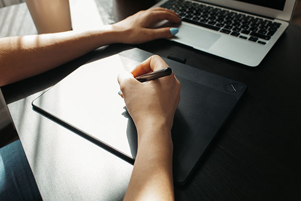 Graphic designer using a drawing digital board